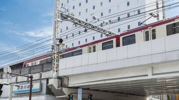 A hotel with a modern design, located near a train station.