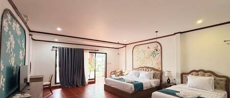 A hotel room with two beds, a desk with a chair, a TV, and a large window with curtains.