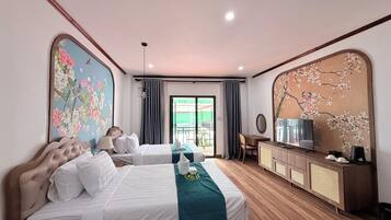 A hotel room with a bed, a desk, a television, and a large window.