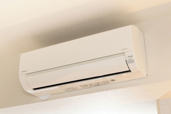 A white air conditioning unit mounted on a wall.