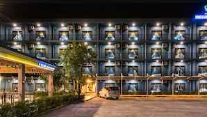 A multi-story hotel with individual rooms, a restaurant, and a parking area. - Nine Blue Residence (Pattaya)