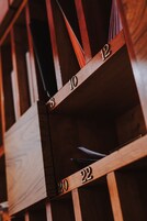 A close-up of a wooden shelving unit with numbered compartments, likely part of a storage or organizational system.