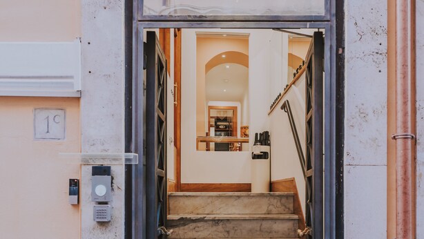 A staircase leading to a second-floor apartment with a view of the interior. - Albergo delle Regioni (Rome)
