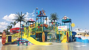 A water park with a large slide, a wave pool, and a beach-themed building. - The Encore Club #4 - 10 Bed 10 Baths Villa (Kissimmee)
