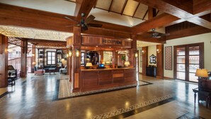 A reception area with wooden beams, a ceiling fan, and a reception desk. - Le Bel Air Resort Luang Prabang (Luang Prabang)