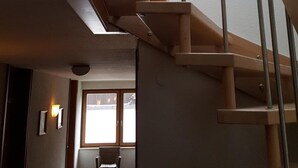 A wooden staircase with a skylight leading to a room with a window. - Gästehaus Ruh (Freiburg im Breisgau)