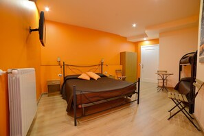 A compact bedroom with a single bed, a small table, a chair, and a wardrobe. - B&B Patty's House (Adrano)
