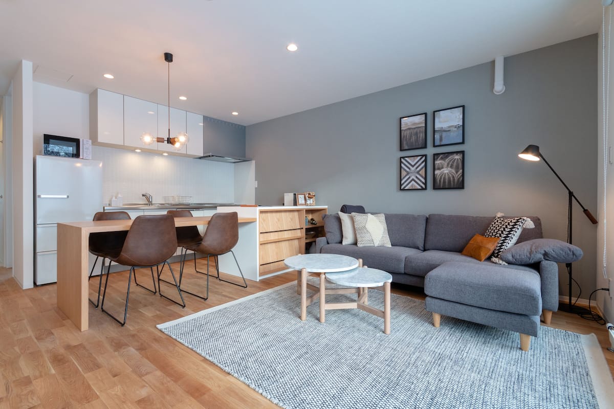 A modern living space with a kitchen, dining area, and seating area.