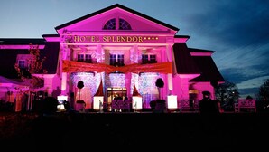 A hotel named 'Hotel Splendor' with a prominent marquee and illuminated signage.