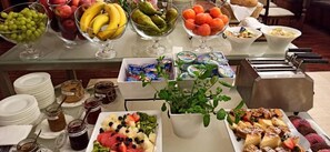 A buffet table with various food items and condiments.