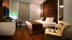 A modern hotel room with a large bed, a desk with a chair, a sofa, and a large window. - H Boutique Hotel Sri Petaling (Kuala Lumpur)