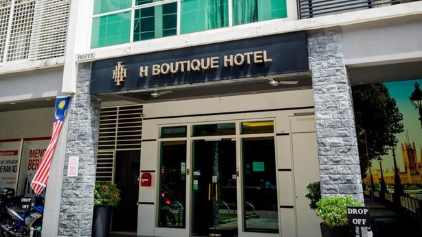 A hotel with a modern facade, large windows, and a sign indicating it is the H Boutique Hotel. - H Boutique Hotel Sri Petaling (Kuala Lumpur)