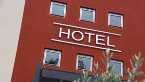A hotel sign with the word "HOTEL" in large letters, flanked by windows. - Landhotel Neunburg (Neunburg vorm Wald)