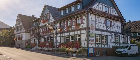 A traditional half-timbered building with a sign indicating it is a hotel.