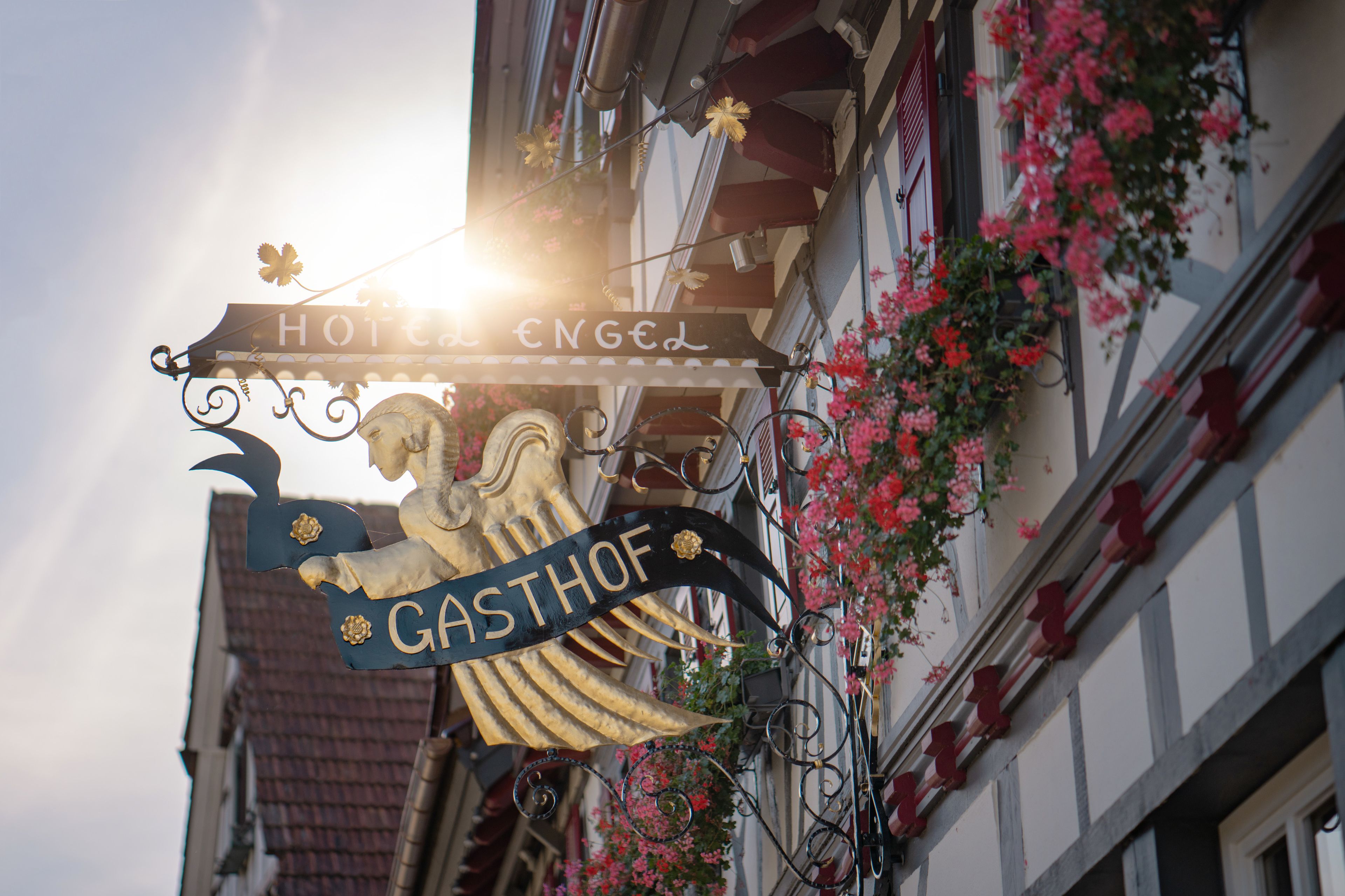 A hotel sign with "HOTEL ENGEL" and "GASTHOF" indicating a traditional establishment.