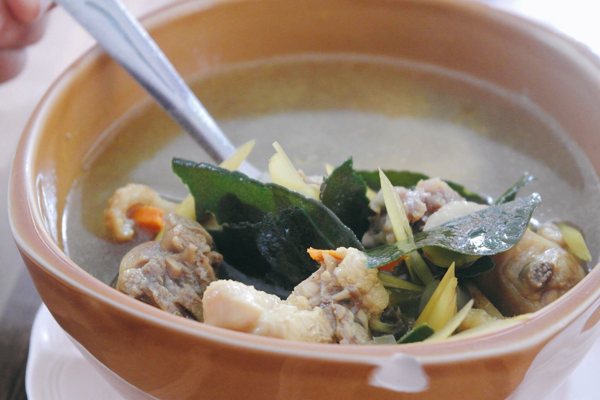 A bowl of soup with various ingredients.