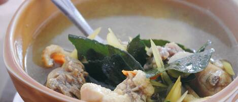 A bowl of soup with various ingredients.
