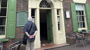 A brick building with the sign "Tontine Hotel" above the entrance. There are green shutters on the windows, and a person is standing in front of the entrance. - Tontine Hotel & Bar (Telford)