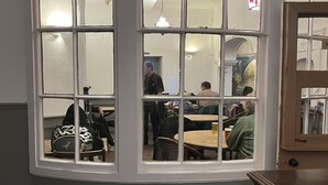 A room with a bay window overlooking a dining area. - Tontine Hotel & Bar (Telford)