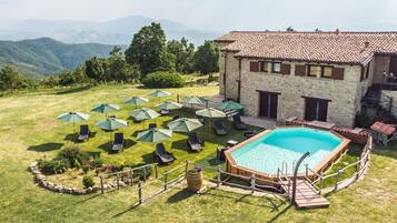 Seasonal outdoor pool, open 10:00 AM to 7:00 PM, pool umbrellas