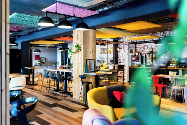 A modern interior with a bar area, seating, and a visible kitchen.
