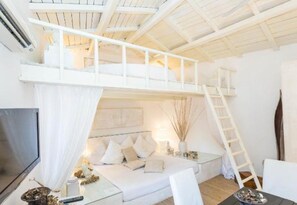 A bedroom with a bunk bed, a TV, a bedside table, and a ladder. - Natural Pantheon  (Rome)
