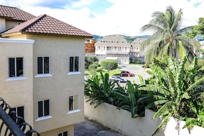 Stunning residential building with an entrance and lush greenery.