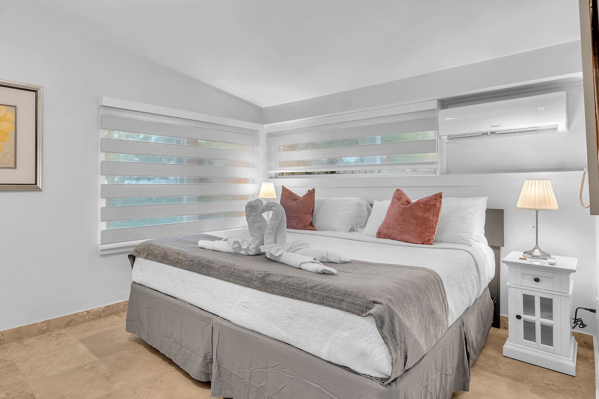Premium bedding, Tempur-Pedic beds, laptop workspace, blackout drapes