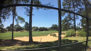 A golf course with sand bunkers and trees. - Kokomo House Holiday home 3 Bedroom (Haines City)