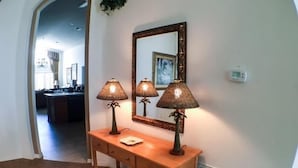 A wooden console table with two lamps and a mirror. - St Kitts House Holiday home 4 Bedroom (Haines City)