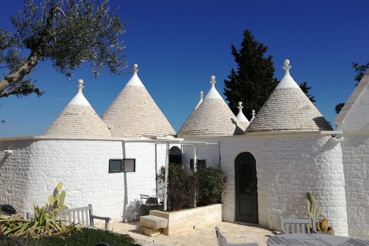A building with multiple conical roofs and a white exterior.
