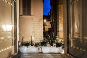Stroll down this charming alleyway to the entrance of a traditional building.