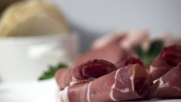 A plate of sliced cured meat with a white background.