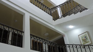 A multi-level building with balconies featuring ornate black railings.