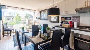 Una cocina moderna con comedor, ventanas amplias y vista a la ciudad.