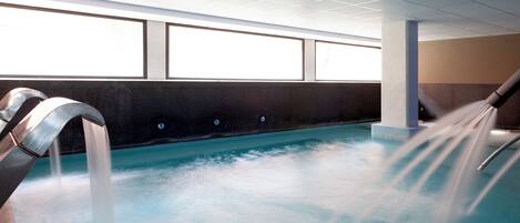 A spa area with a hot tub and a water fountain.