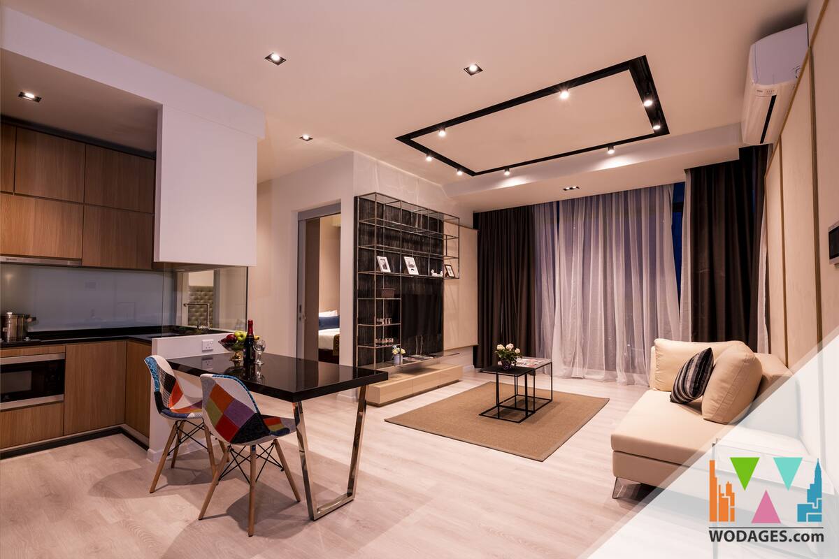 A modern living room with a sofa, a dining table with chairs, a kitchen area, and a built-in bookshelf.