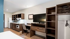 A compact kitchen with a refrigerator, microwave, and sink. - WoodSpring Suites Reno Sparks (Sparks)