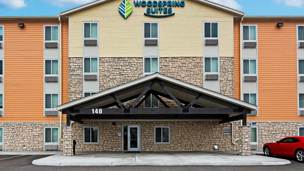 A multi-story hotel with a stone facade and a flat roof. - WoodSpring Suites Reno Sparks (Sparks)