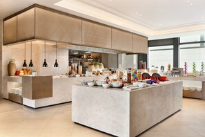 A modern kitchen with marble countertops, hanging pendant lights, and a variety of kitchenware and appliances. - Hyatt Place Chengdu Pebble Walk (Chengdu)