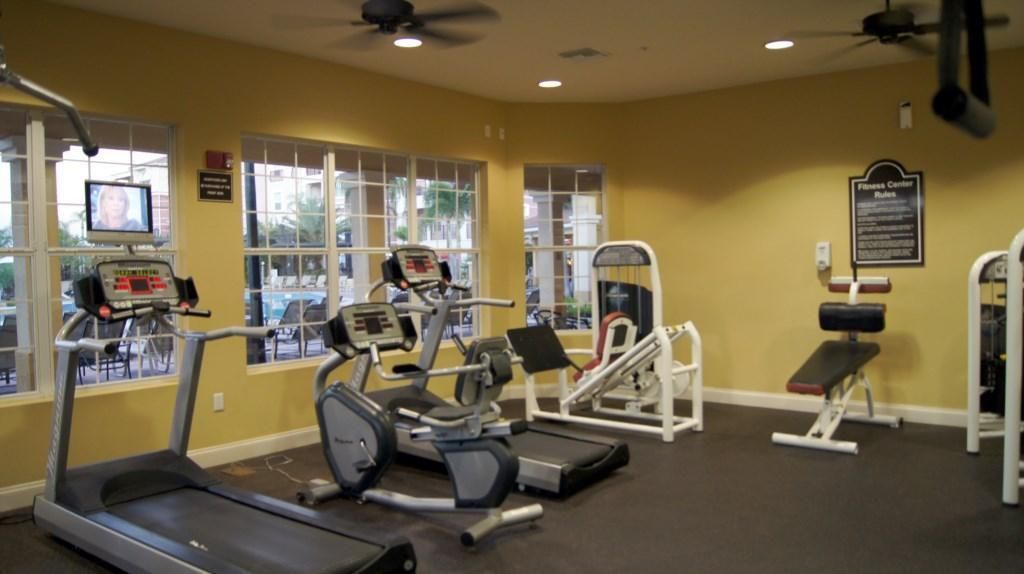A gym with treadmills, elliptical machines, and weight equipment.