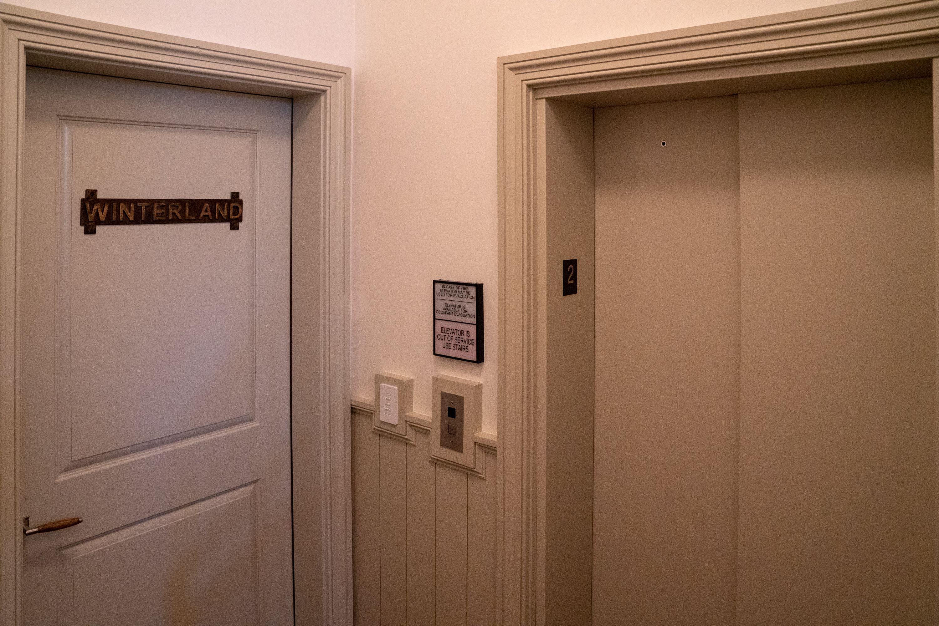 Two doors, one labeled "Winterland" and another with a number "2" above it. There is a sign on the wall indicating the elevator is out of service and to use the stairs.