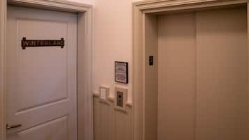 Two doors, one labeled "Winterland" and another with a number "2" above it. There is a sign on the wall indicating the elevator is out of service and to use the stairs.