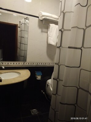 A bathroom with a sink, mirror, towel rack, toilet, and shower curtain. - S Chalet Bhurban (Murree)