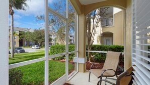 A balcony with a view of a well-maintained lawn and neighboring buildings. - Windsor Palms Resort (Kissimmee)