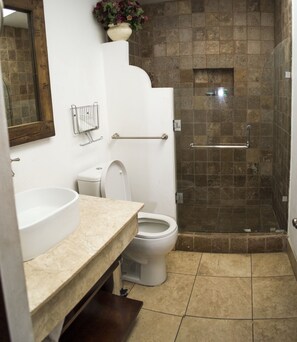 A bathroom with a sink, toilet, and glass-enclosed shower stall. - Dream Villas Antigua (Antigua Guatemala)