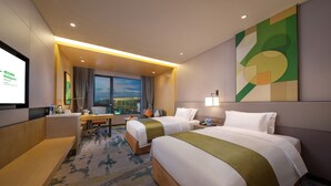 A hotel room with two beds, a desk, a chair, a TV screen, and a large window with a city view. - Holiday Inn Hangzhou Airport Zone by IHG (Hangzhou)