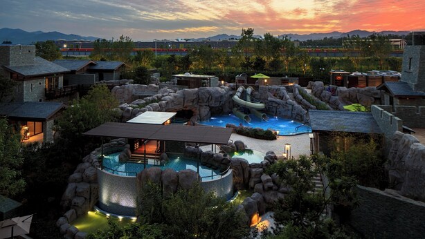 A resort with multiple pools, rock formations, and a sunset view. - Beijing Marriott Hotel Changping (Changping)