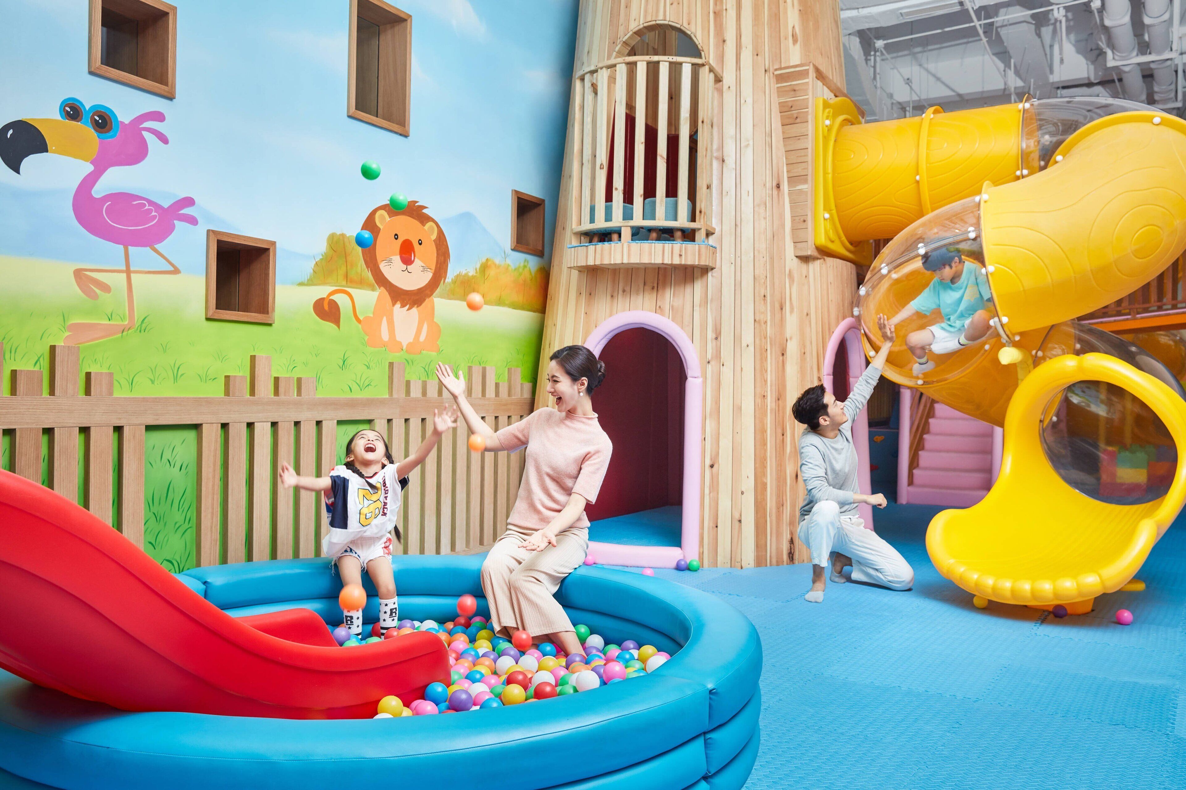 A play area with a slide, ball pit, and climbing structures.