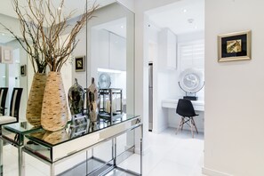 Enjoy a spacious room with a glass-top dining table, large mirror, and a dedicated workspace.